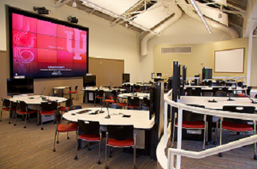 Image of Collaboration Studio showing student tables with monitors and video wall.
